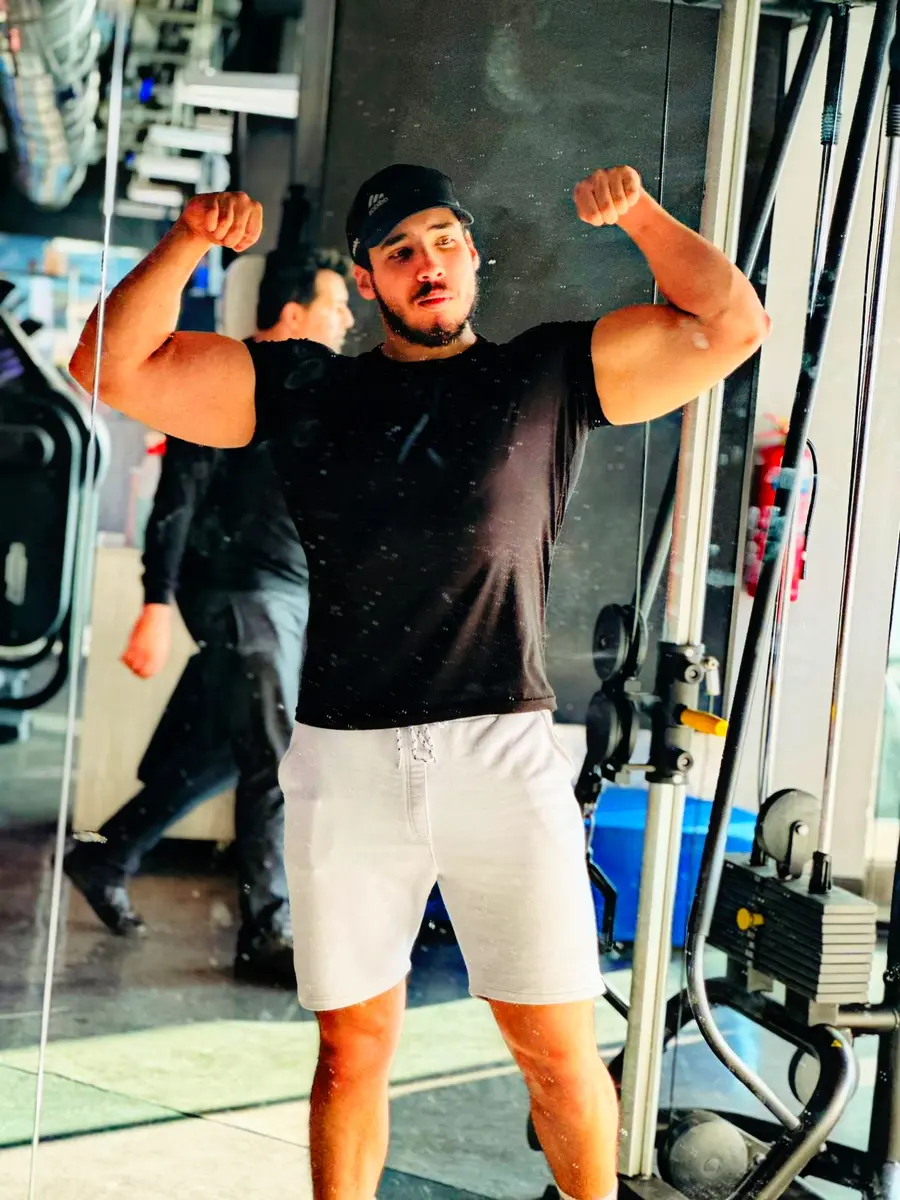 Personal trainer Karim flexing after a training session