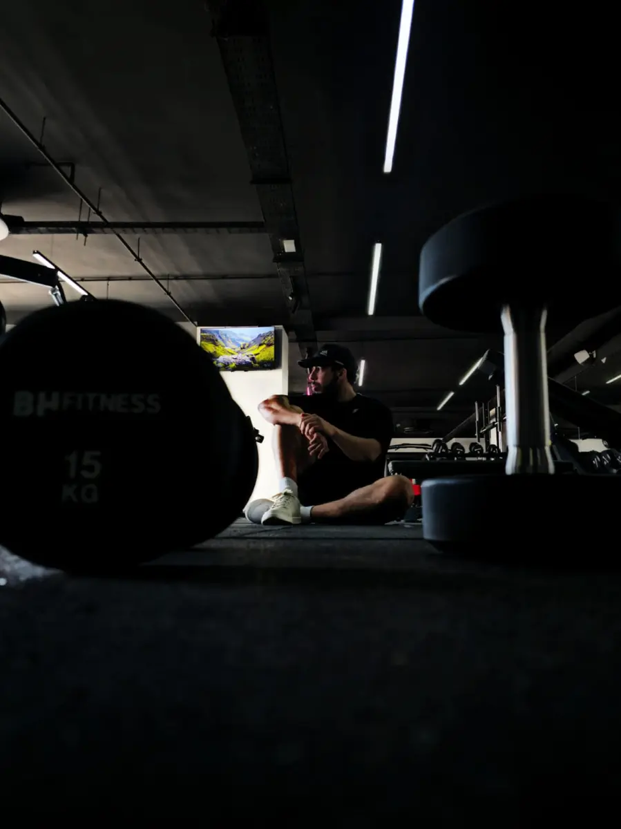 Personal trainer Karim resting between sets in the gym